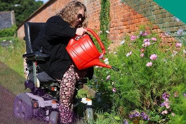 Lady with Watering Can at the community garden